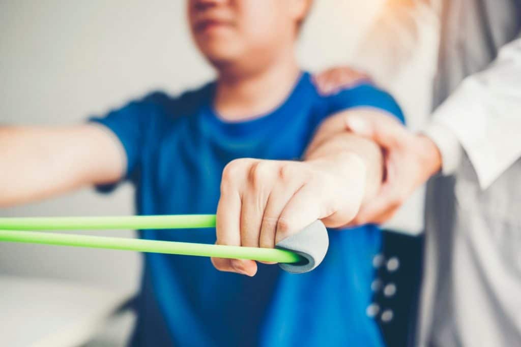 Physiotherapist treating patient's arm and shoulder